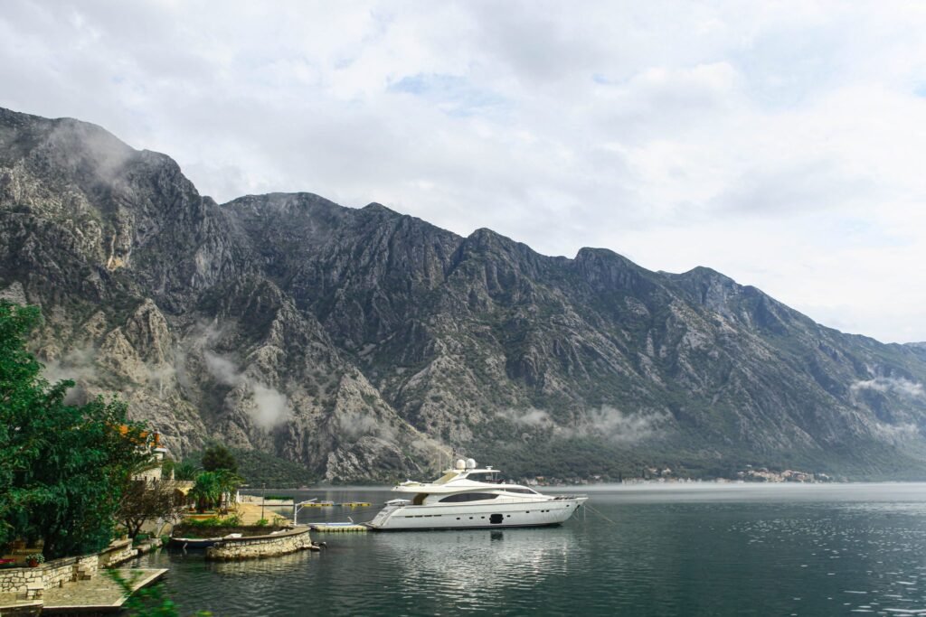 White motor yacht moored in a mountain bay