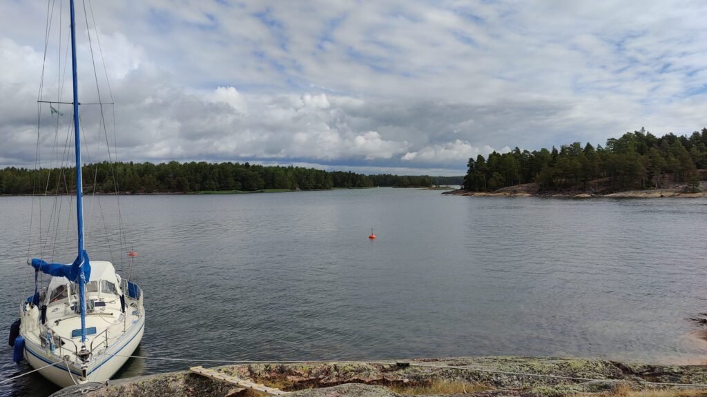 Sailboat moored at a rocky shore